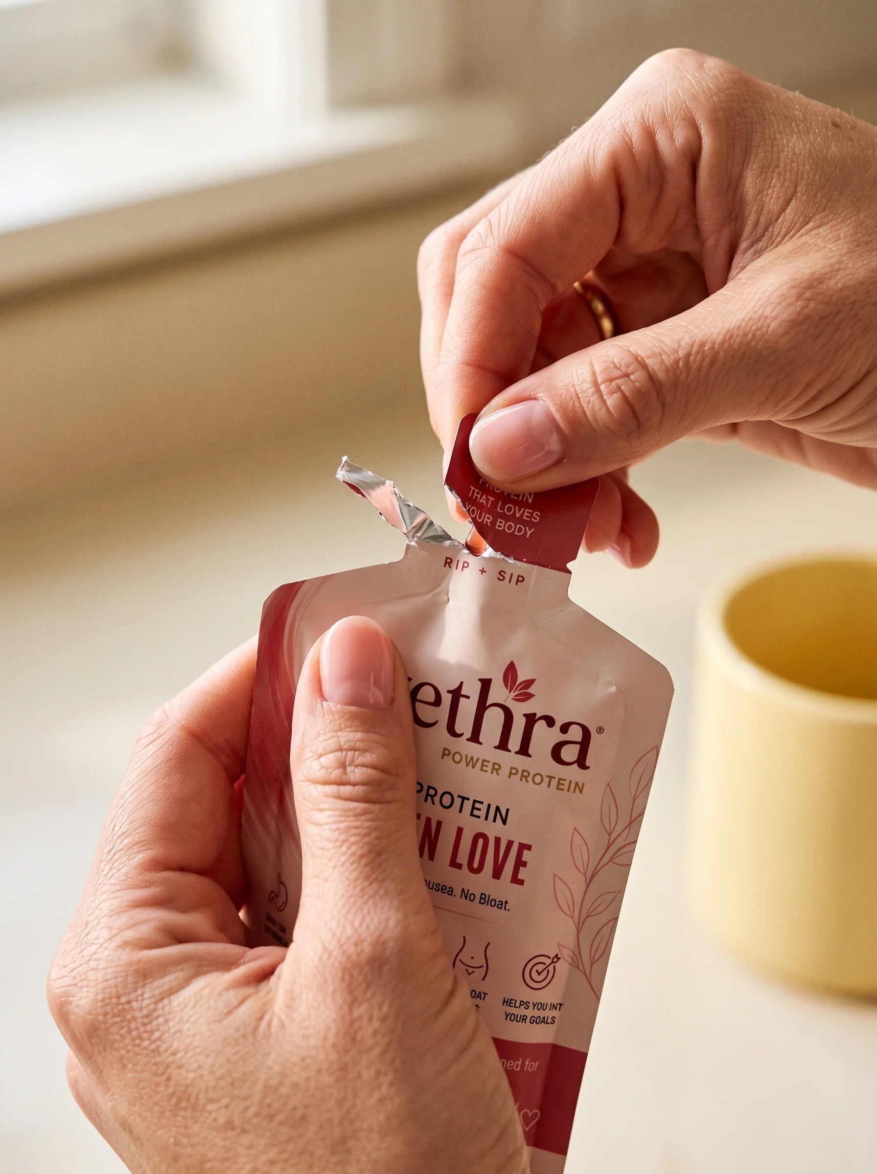 Woman tearing open an Evethra collagen protein shot sachet